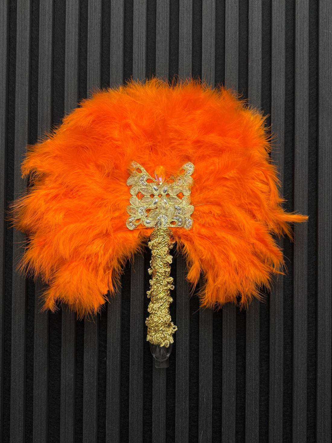 Orange feathered handfan with gold inlays